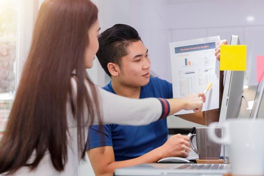 Asian small business startup multiracial working at Private Home Office social distancing among Coronavirus outbreak. Business people show and talking about document chart financial report. 