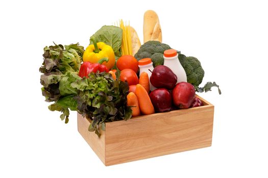 Wooden crate with multi collor vegetables , fruit, milk and baguette isolated on white background. Grocery in wood crate . Save with clipping path