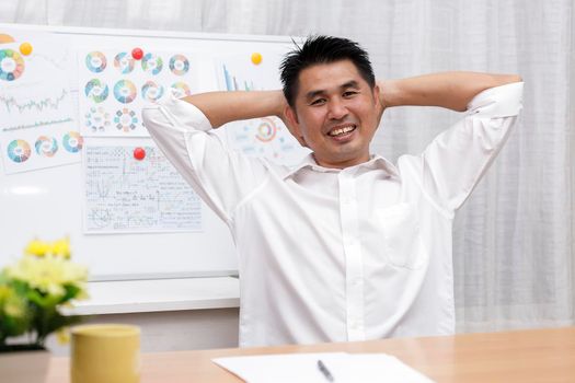 Asian businessman sitting at home office look at camera doing online work interview during vide conference chat. Webcam view. Business people smiling using video call contact with friend, customers, partners from home