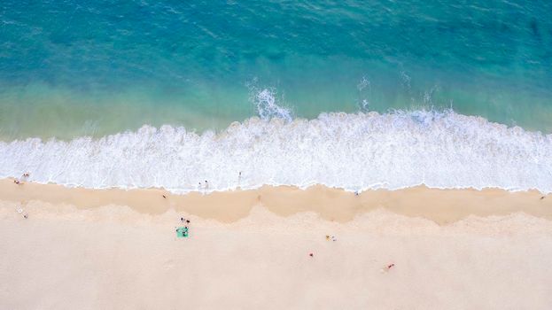 Aerial drone top view crowd of happy people relax at tropical Beach with sunset in Phuket, Thailand, Beautiful Phuket beach is famous tourist destination at Andaman sea. Holiday summer concept