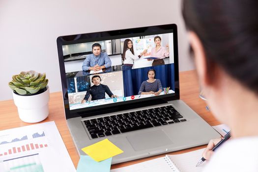 Businessman and businesswoman analysis financial chart with videoconference online meeting. Hand of businesswomen using laptop meeting with diverse colleagues. Covid-19 working from home. With copy space banner