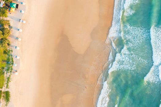 Aerial drone top view crowd of happy people relax at tropical Beach with sunset in Phuket, Thailand, Beautiful Phuket beach is famous tourist destination at Andaman sea. Holiday summer concept