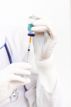 Doctor filling syringe with medication, closeup. Vaccination and immunization. Selective focus. Vaccine.