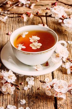 Cup of tea and spring flowers on a wooden background. Selective focus.nature