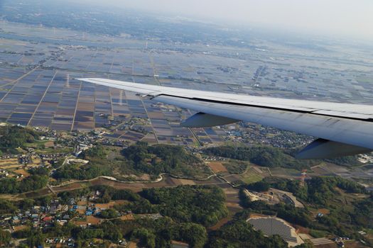 view from a plane on wing and on rural Japan