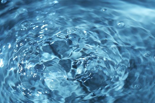 Close-up macro of a wave from water drop droplet