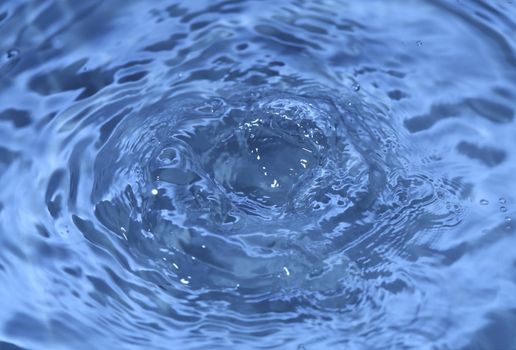 Close-up macro of a wave from water drop droplet