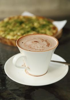cup of hot chocolate with Pizza Japanese style in a cafe