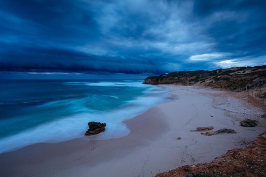 The idyllic Number Sixteen Beach with an incoming storm at dusk in Rye, Victoria, Australia