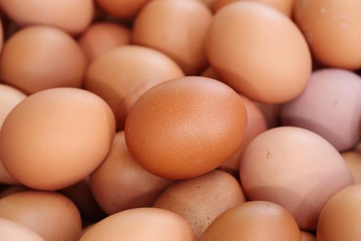 many fresh brown eggs for sale at a market