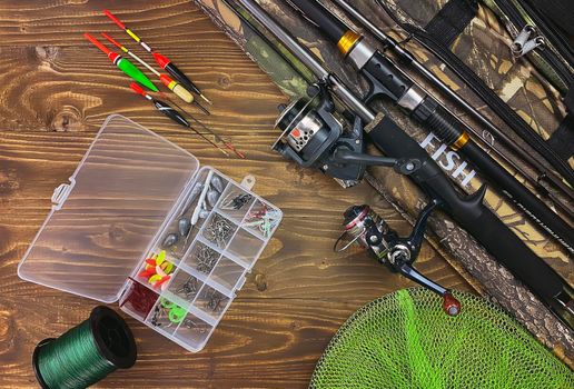 Fishing tackle. Float, wobbler, bait hooks, on a wooden background. Selective focus