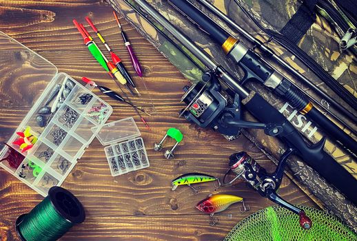 Fishing tackle. Float, wobbler, bait hooks, on a wooden background. Selective focus