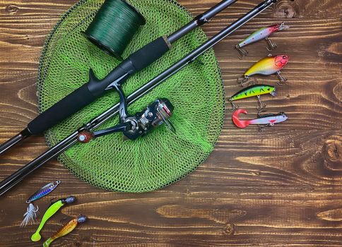 Fishing tackle. Float, wobbler, bait hooks, on a wooden background. Selective focus