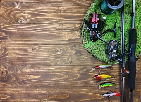 Fishing tackle. Float, wobbler, bait hooks, on a wooden background. Selective focus