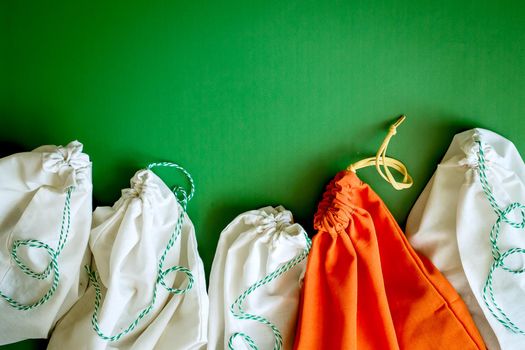 zero waste products in reusable cotton bags on a green background. High quality photo