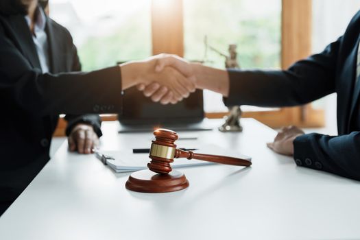 Law, consultation, agreement, contract, lawyer or attorney shakes hands to agree on the client's offer to be hired to fight the parties in court