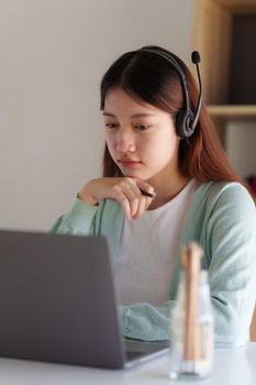 E-learning ,online ,education and internet social distancing protect from COVID-19 viruses concept. Asian woman student video conference e-learning with teacher on laptop computer at home