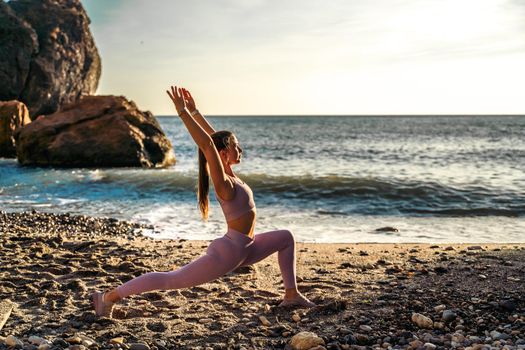 Girl gymnast is training on the beach by the sea. Does twine. Photo series.