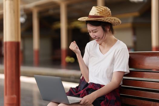 Pretty Young traveler woman excite and planning trip at train station. Summer and travel lifestyle concept