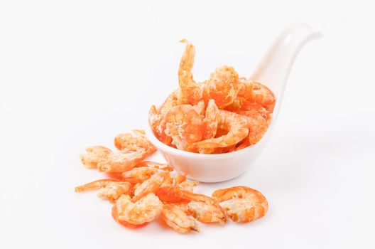 Dried shrimp in white spoon isolated on white background.