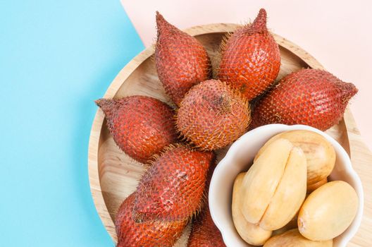 The Salak Palm , waive or snake fruit in wooden dish on table.