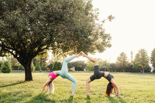 2 girl doing outdoor sport training and yoga in the park