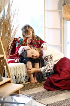 Ukraininan family wearing ethnic style embroidered shirt, modern derivative from traditional Ukrainian vyshyvanka.