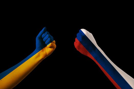 Fist fight flags of Ukraine and russia on black background. Putin invasion