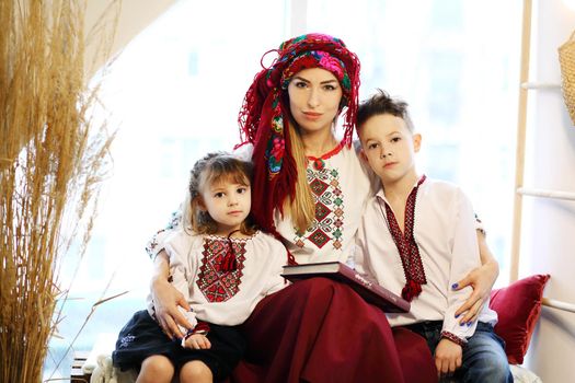 Ukraininan family wearing ethnic style embroidered shirt, modern derivative from traditional Ukrainian vyshyvanka.