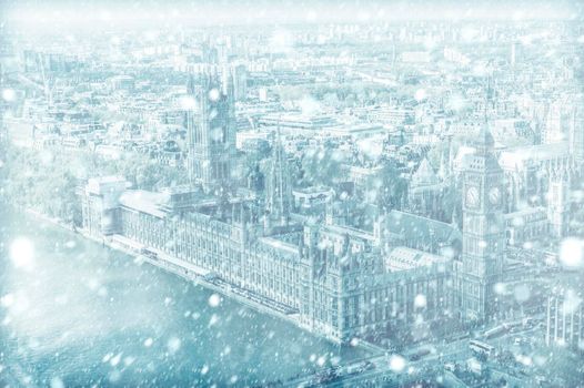 View of House of Parliament with Thames river in London with snow