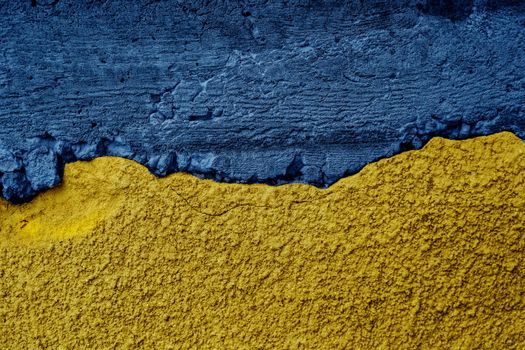 Ukrainian flag on textured wall. Putin invasion. War against Ukraine.