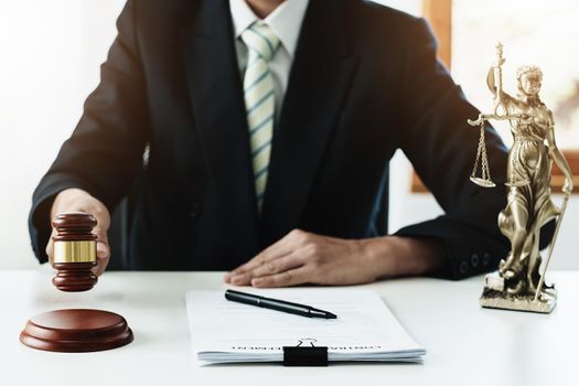 Law, Consultation, Agreement, Contract, Concept Attorney or lawyer focusing on the court hammer is sitting on the chair with a client's complaint to determine the house and land in court.