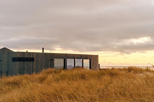 facade of a designer building made of wood on the seashore. modern architecture