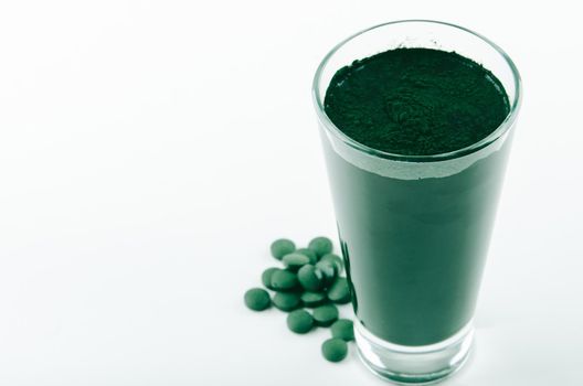 minimalist glass with water and spirulina powder. High quality photo