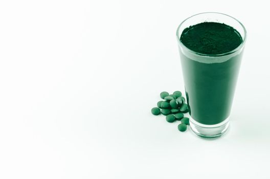 minimalist glass with water and spirulina powder. High quality photo