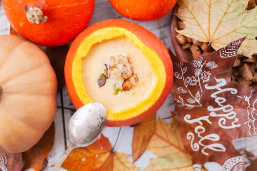 pumpkin cream soup in autumn scenery. High quality photo