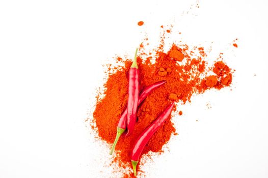 fresh red hot pepper and powder on a white background. High quality photo