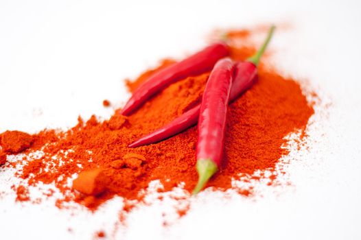 fresh red hot pepper and powder on a white background. High quality photo