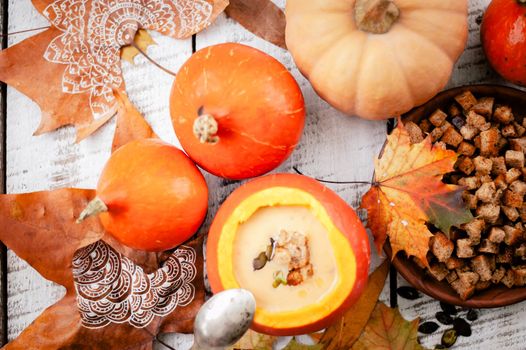 pumpkin cream soup in autumn scenery. High quality photo