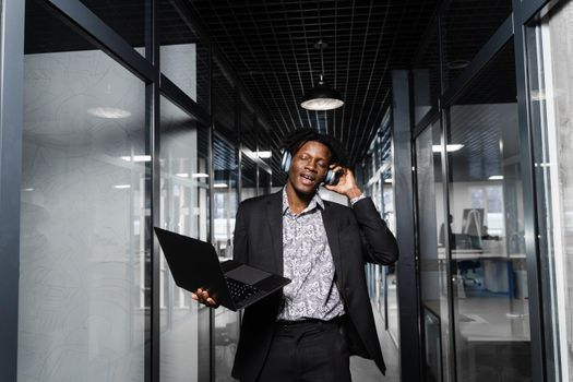 Black skin dj in headphones is listening music, making dj set and dancing. Party lifestyle