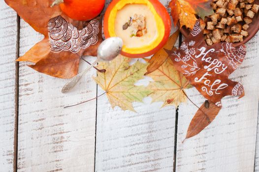 pumpkin cream soup in autumn scenery. High quality photo