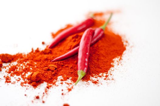 fresh red hot pepper and powder on a white background. High quality photo