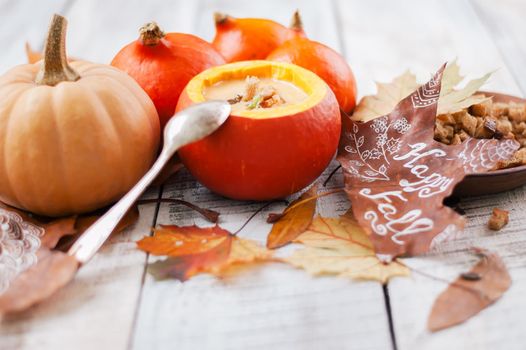 pumpkin cream soup in autumn scenery. High quality photo