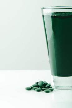 minimalist glass with water and spirulina powder. High quality photo