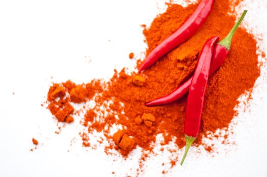 fresh red hot pepper and powder on a white background. High quality photo