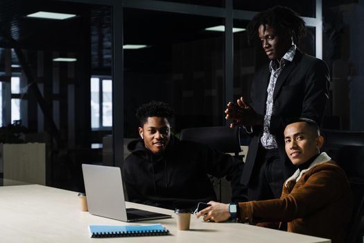 Multinational brainstorm group of colleagues working online on project in briefing room. Black african business man and asian work in team together