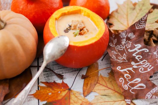 pumpkin cream soup in autumn scenery. High quality photo