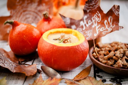 pumpkin cream soup in autumn scenery. High quality photo