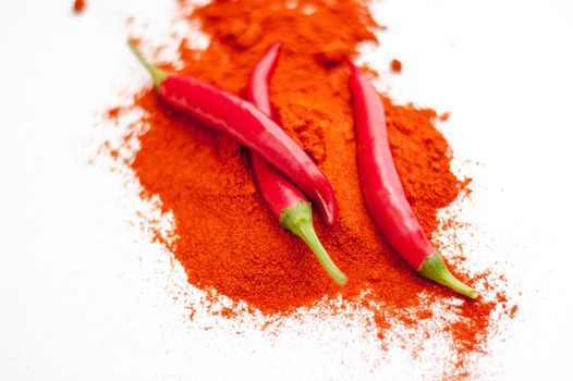 fresh red hot pepper and powder on a white background. High quality photo