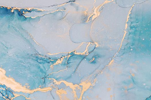 Abstract liquid ink painting background in pastel colors with gold splashes